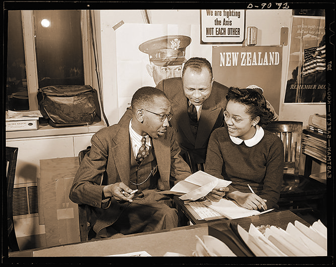 New_York_Post_journalist_Ted_Poston_working_at_the_Office_of_War_Information_with_his_assistants_William_Clark_and_Harriette_Easterlin.jpg
